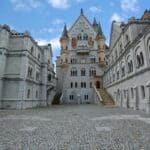 Elegant European castle with turrets and stone architecture for travel photography and historical tours.