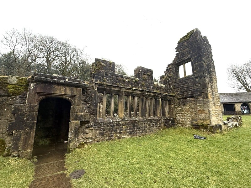 Ruins of Wycoller Hall, a historic and picturesque village site in England, showcasing medieval stone walls and remnants of a bygone era.